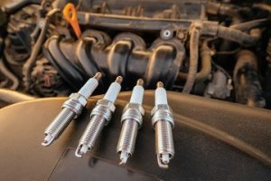 What should I do if there is a worn-out spark plug in my car?